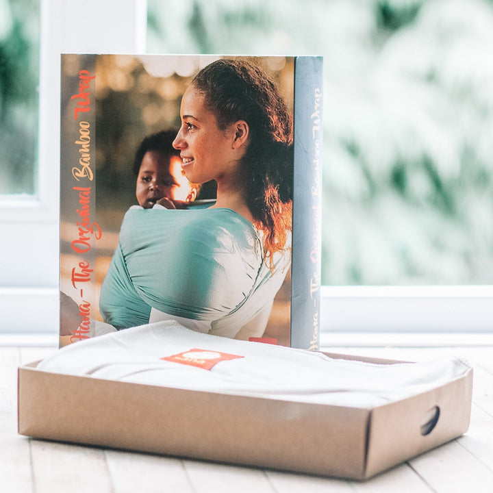 Product packaging with a photo of a woman and child, placed on a white surface.