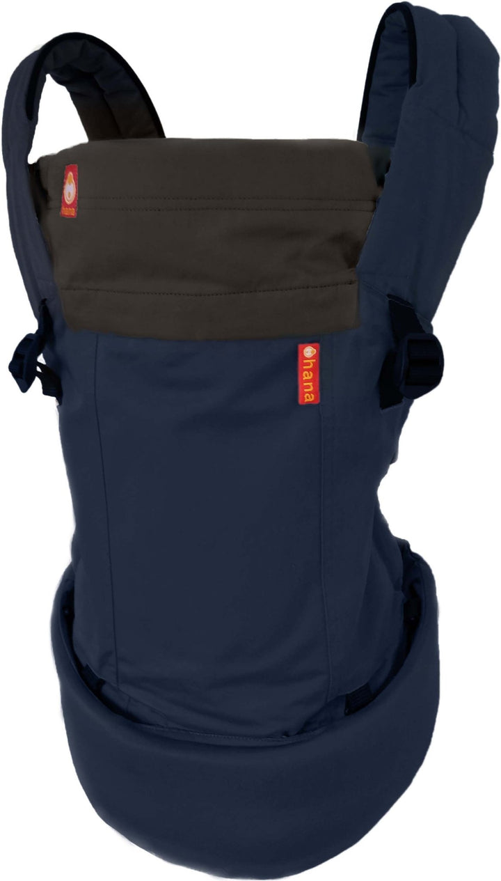 The hana baby expand can be fully adjusted to accommodate newborns making it one of the easiest newborn carriers. This navy carrier is on a white studio background.