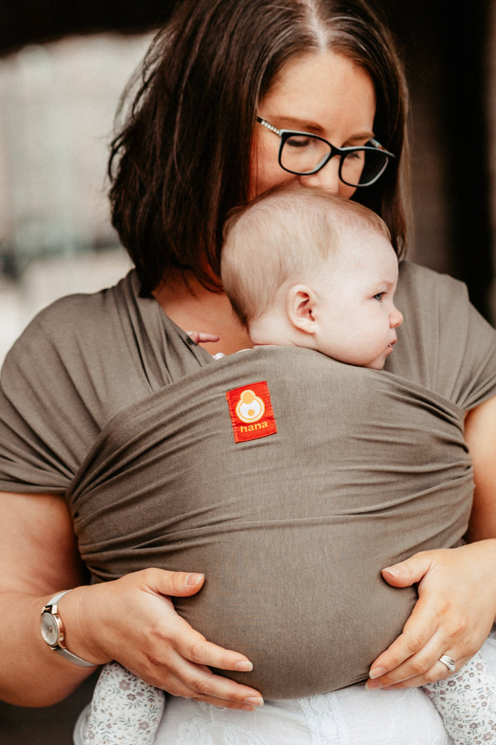 Hana Baby Organic in Olive grey modelled by a mother with glasses and her baby girl. 